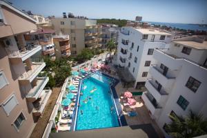 an overhead view of a swimming pool between buildings at Tuntas Suites Altinkum in Didim