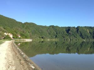 a view of a body of water with trees at Casa Dos Barcos Furnas in Furnas