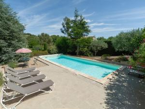 una piscina con 2 tumbonas junto a ella en Holiday Home Les Iris by Interhome, en Gargas