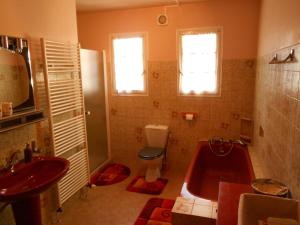 a bathroom with a tub and a toilet and a sink at Chambres d'hôtes Al Camp d'Espalougues in Ur +26 photos