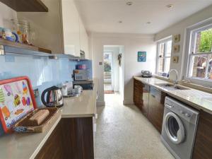 a kitchen with a washer and dryer on a counter at Holiday Home Kingsgate Bay by Interhome in Kingsgate