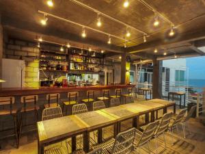 a restaurant with tables and chairs and a bar at Sugarsea Inn & Dive shop in Mactan