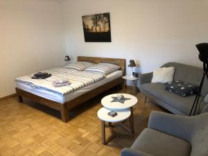 a bedroom with a bed and a couch and a table at Am Grünenplatz 65 in Wermelskirchen
