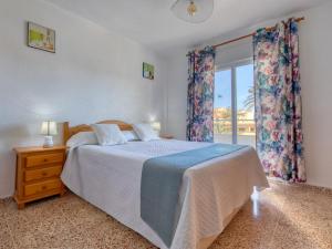 a bedroom with a large bed and a window at Apartment Don Pepe-5 by Interhome in Balcon del Mar