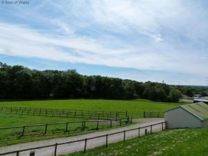 a road in a field with a fence at Holiday Home Cwm Tawel by Interhome in Pentyrch