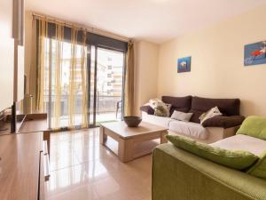 a living room with a couch and a table at Apartment La Goleta bajos by Interhome in Cambrils +21 photos