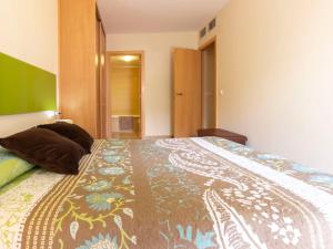 a bedroom with a large bed with a colorful bedspread at Apartment La Goleta bajos by Interhome in Cambrils