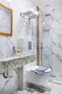 a bathroom with a toilet and a sink and a shower at Okean Studios in Ierissos