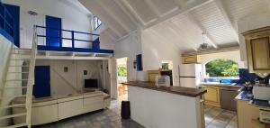 a kitchen with a loft bed in a room at Villa la GAIA in Grand-Bourg