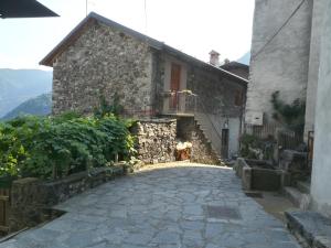 a stone house with a stone driveway at LA PICCIONAIA in Varallo