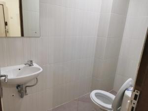 a bathroom with a sink and a toilet at Hotel Nusantara Indah Syariah in Jakarta