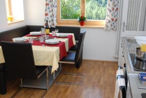 a dining room table with a red and white table cloth at Appartment Gsolerhof in Castelrotto +27 photos