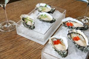 a group of oysters on ice on a table at Fletcher Hotel-Restaurant De Oude Gevangenis-Alkmaar in Alkmaar