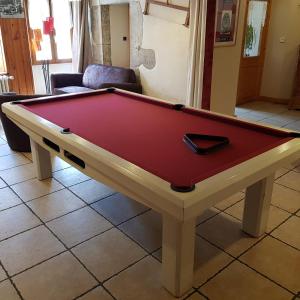 a red pool table in a living room at Auberge des Montauds in Villard-de-Lans