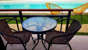 a table with two chairs and a table with a glass top at Positano Alona Beach Panglao in Panglao