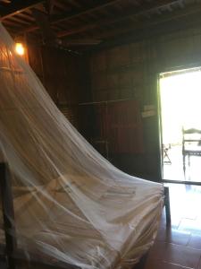 a mosquito net in a room with a window at Malayalam Lake Resort in Alleppey