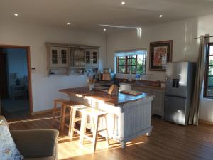 a kitchen with a island in the middle of a room at Kliphuisjes in Dullstroom