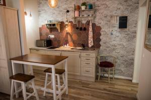 a kitchen with a table and a table and chairs at All In Apartman IV. in Budapest