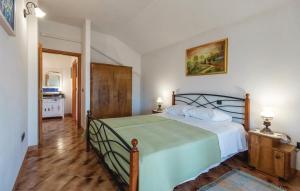 a bedroom with a bed with a green bedspread at Holiday House Klarin with Sea View in Preko