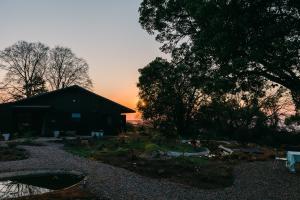 a barn with a tree and a sunset in the background at The Croft in Hilton