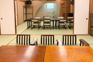 a dining room with a table and chairs at Tabist Ooriya Kochi in Sagamichō