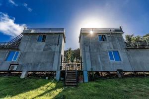 a building with a staircase in front of it at Saipan Skyline Designers Hotel in Saipan