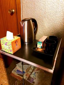 a table with a tea kettle and a box on it at Alicante Room and gayfriendly in Alicante