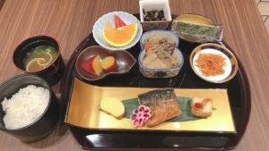 a tray of food with sushi and rice on a table at S.Training Center Hotel Osaka in Osaka