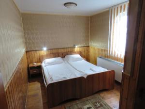 a small bedroom with a bed and a window at Hotel Plutitor Carpatia St. Constantin in Sulina