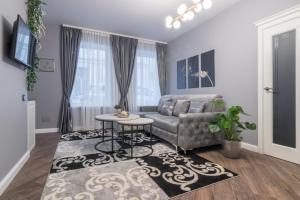 a living room with a couch and a table at Dandelion apartment in the heart of Kaunas in Kaunas