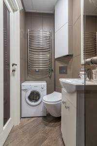 a bathroom with a washing machine and a sink at Dandelion apartment in the heart of Kaunas in Kaunas