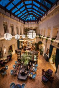 an overhead view of a lobby with tables and chairs at The Merchant Baku in Baku