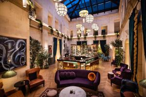 a lobby with couches and a bar in a building at The Merchant Baku in Baku