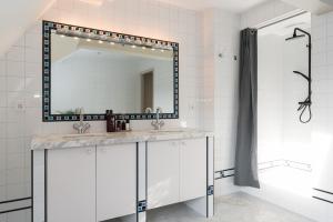 a bathroom with a sink and a mirror at Empire suites roof terras in Amsterdam