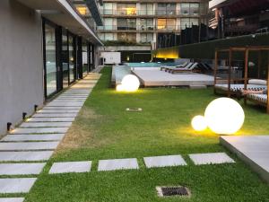 a courtyard with grass and lights in a building at Lumiere Puerto Madero in Buenos Aires