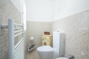 a small bathroom with a toilet and a sink at Realkasa Senzanome Flat in Bologna