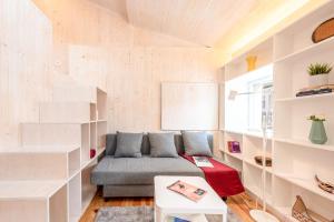 a living room with a couch and shelves at GuestReady - Beco do Garcês Apartment in Lisbon