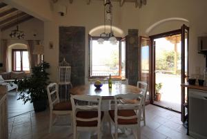 a kitchen and dining room with a table and chairs at Grand View Afrodite in Mithymna