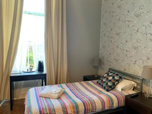a small bedroom with a bed and a window at Northumberland Hotel in Edinburgh