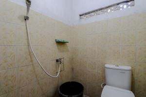 a bathroom with a shower with a toilet at Omah Nggunung Cafe & Homestay in Yogyakarta