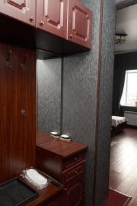 a room with a mirror and a wooden cabinet at Sun City Hotel in Solnechnogorsk
