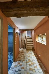 a hallway of a home with a staircase and a room at Gîte La Terrasse - Manoir le Plessix Madeuc in Corseul