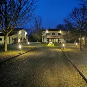 an empty road in front of a house at night at La Villa di Arezzo in San Zeno