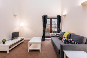 uma sala de estar com um sofá e uma televisão em Elliot Suite No 1 - Donnini Apartments em Ayr