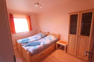 a small bedroom with a bed and a window at Velence Lake Apartman in Gárdony