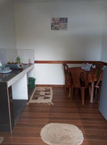 a kitchen with a table and a dining room at Green Gregory Villa Nuwara Eliya in Nuwara Eliya