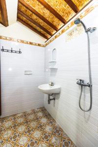 
a bathroom with a toilet, sink, and shower at Dekwah Homestay in Ubud
