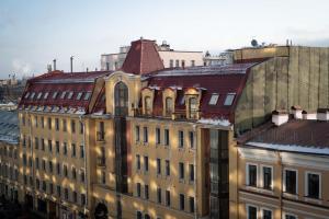 a large building with a red roof at Strawberry Duck St. Petersburg in Saint Petersburg