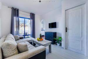 a living room with a couch and a table at BLUE SEA apartment in Torrevieja