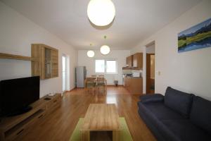 a living room with a couch and a table at Apartman 502 in Ružindol